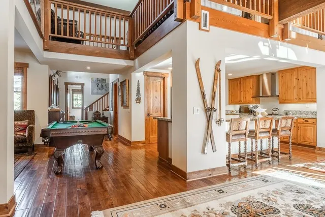 a view of living room kitchen with furniture and wooden floor