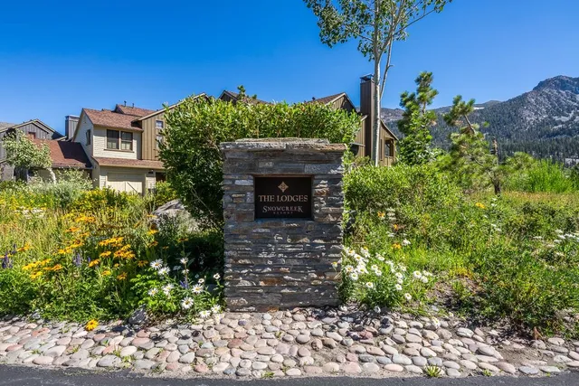 a view of a white house with large windows