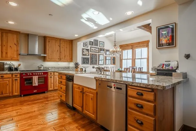 a kitchen with stainless steel appliances granite countertop a sink stove and cabinets