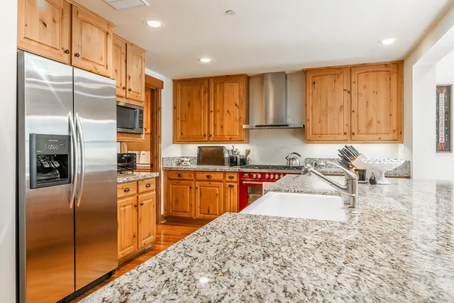 a kitchen with stainless steel appliances granite countertop a refrigerator sink and cabinets
