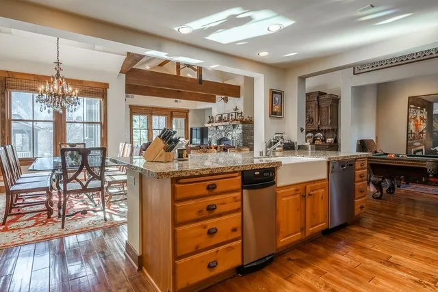 a kitchen with stainless steel appliances granite countertop a stove a sink and a refrigerator