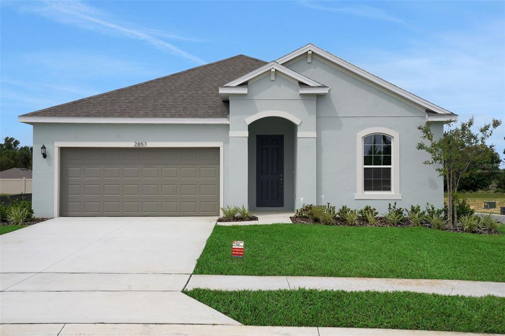 2857 Doolittle Street Tavares, FL 32778 - Photo 1 of 31 a front view of a house with a garden