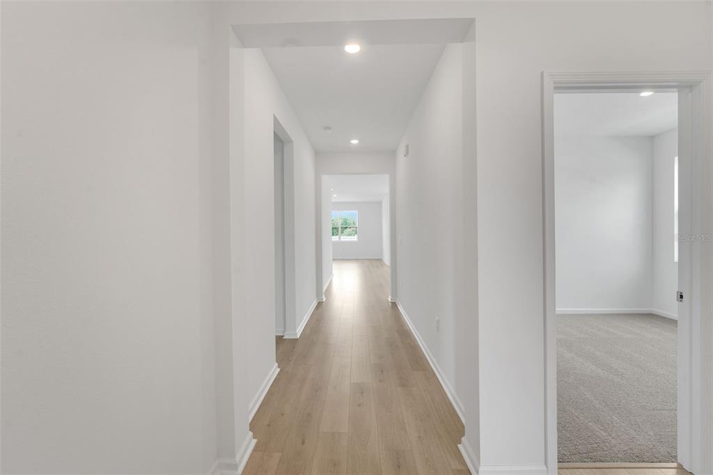 2857 Doolittle Street Tavares, FL 32778 - Photo 16 of 31 a view of a hallway with wooden floor