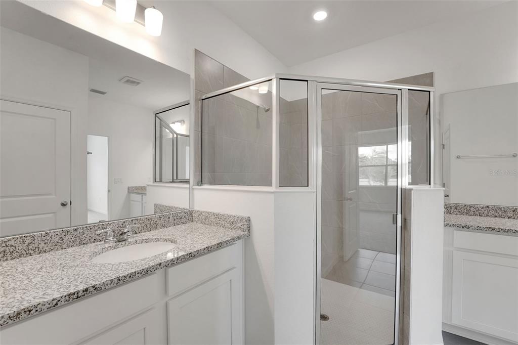 2857 Doolittle Street Tavares, FL 32778 - Photo 19 of 31 a bathroom with a granite countertop sink and shower