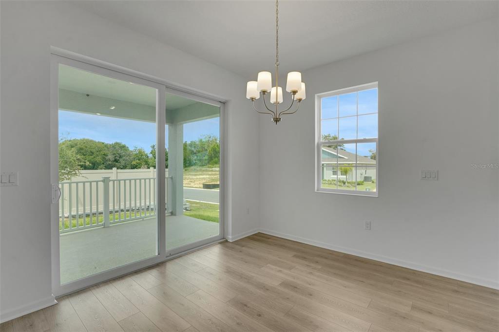 2857 Doolittle Street Tavares, FL 32778 - Photo 25 of 31 a view of a room with wooden floor a chandelier and windows