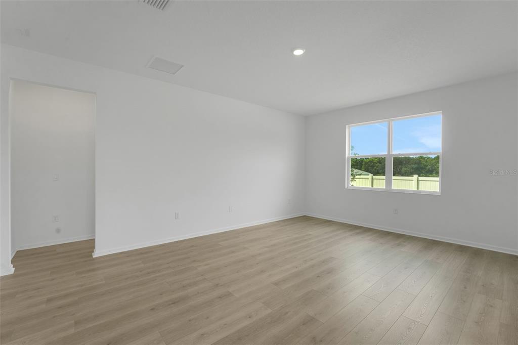 2857 Doolittle Street Tavares, FL 32778 - Photo 26 of 31 an empty room with wooden floor and windows