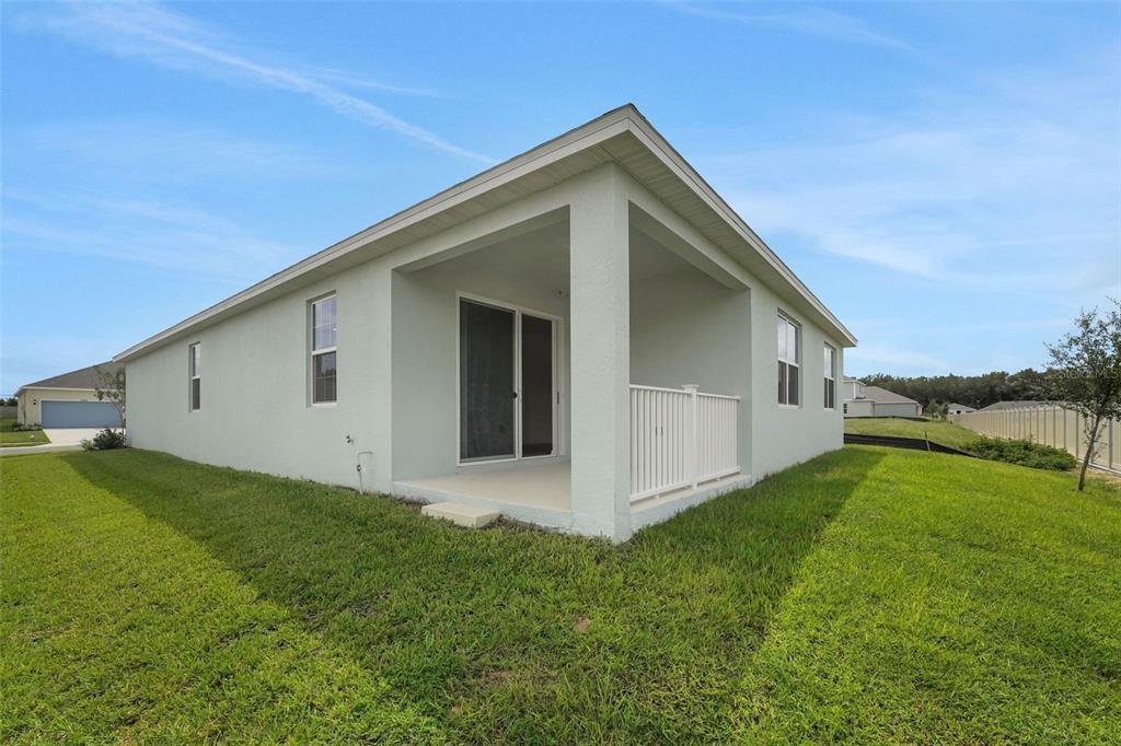 2857 Doolittle Street Tavares, FL 32778 - Photo 31 of 31 a view of an house with backyard space and garden