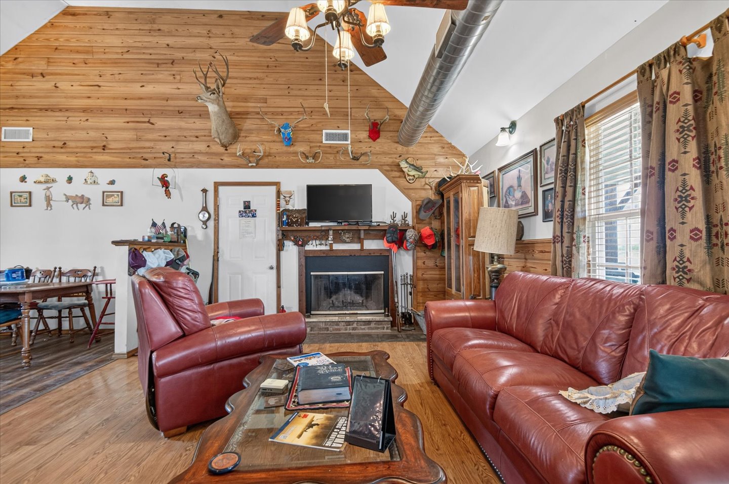 26115 4157th Road Nowata, OK 74048 - Photo 6 of 36 Vaulted wood-beamed ceiling with skylights floods this open living area with natural light