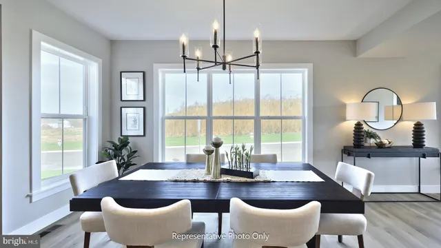 a dining room with furniture a chandelier and wooden floor