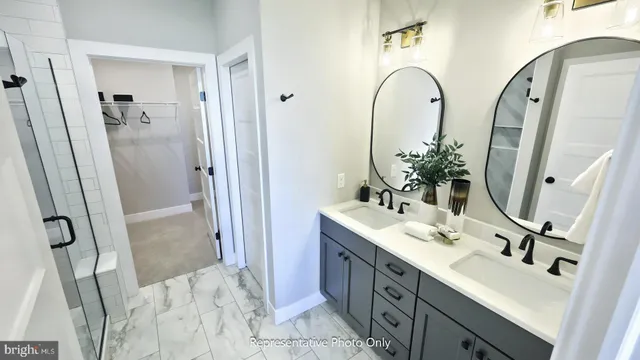 a bathroom with double vanity sink and a mirror