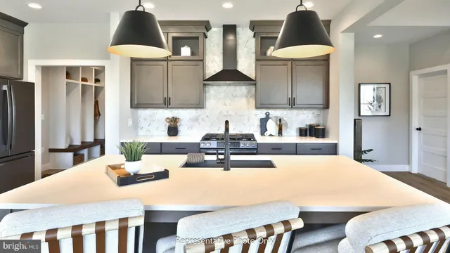 a kitchen with stainless steel appliances a sink a table and chairs