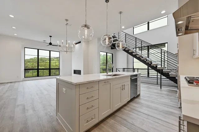 a view of a kitchen with wooden floor and a sink