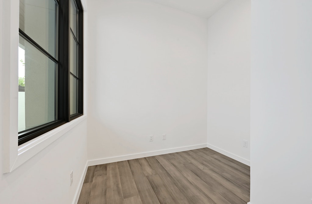 6805 Adeline Way, Unit 17 Austin, TX 78746 - Photo 16 of 38 Unfurnished room with light wood-type flooring and baseboards
