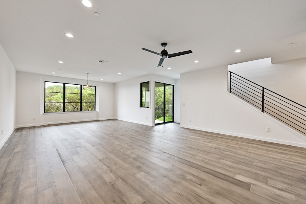 6805 Adeline Way, Unit 17 Austin, TX 78746 - Photo 18 of 38 Unfurnished living room featuring recessed lighting, stairway, light wood-style flooring, and a ceiling fan
