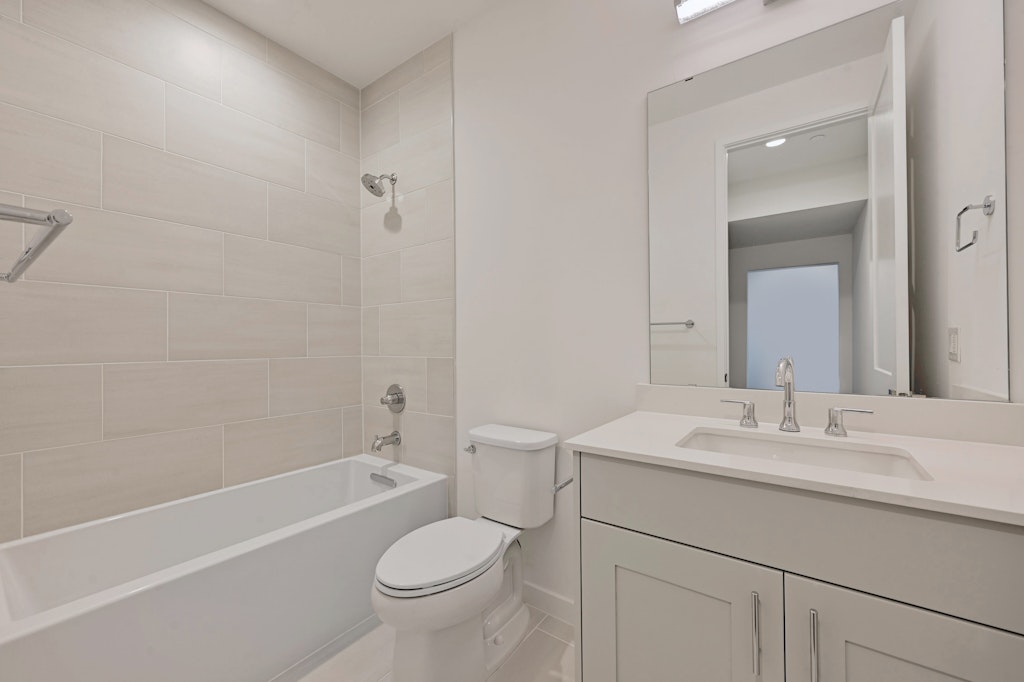6805 Adeline Way, Unit 17 Austin, TX 78746 - Photo 20 of 38 Bathroom with shower / tub combination, vanity, and light tile patterned floors