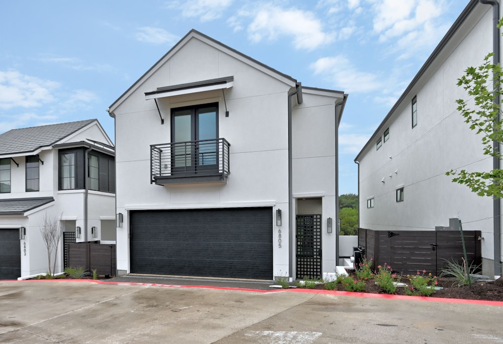 6805 Adeline Way, Unit 17 Austin, TX 78746 - Photo 2 of 38 Contemporary house with a balcony, stucco siding, an attached garage, and concrete driveway