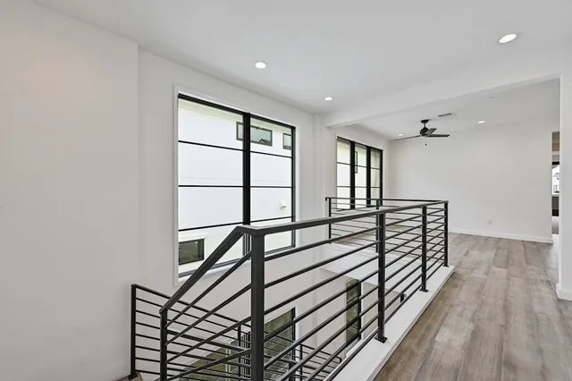 a view of staircase with wooden floor and a window