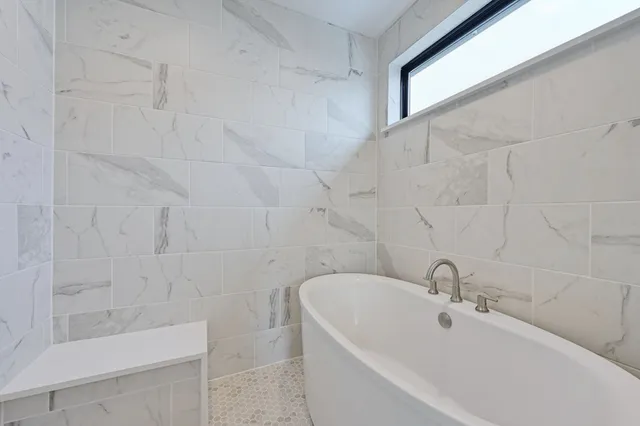 a bathroom with bathtub sink