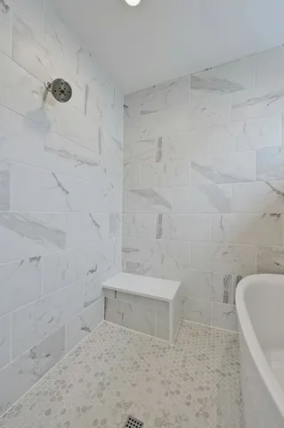 a bathroom with a bathtub and shower