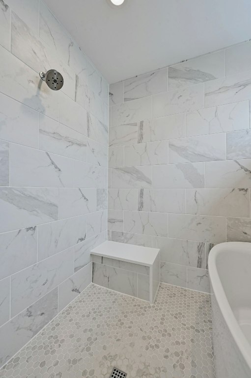6805 Adeline Way, Unit 17 Austin, TX 78746 - Photo 28 of 38 Full bathroom with a freestanding tub, tiled shower, and tile walls