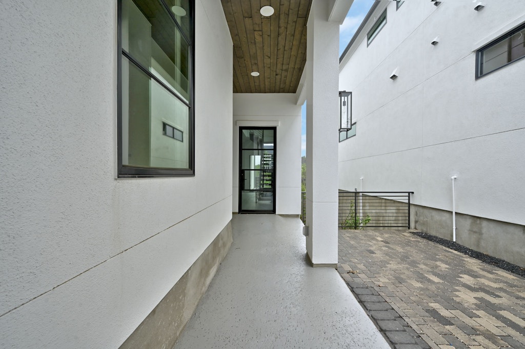 6805 Adeline Way, Unit 17 Austin, TX 78746 - Photo 3 of 38 Property entrance featuring a patio area and stucco siding