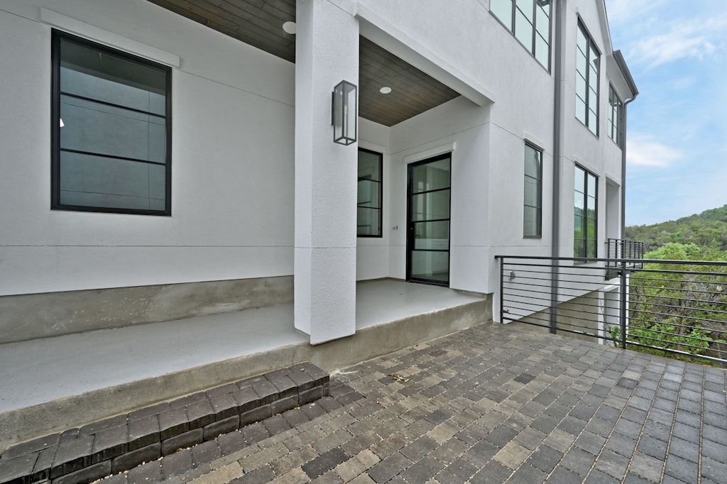 6805 Adeline Way, Unit 17 Austin, TX 78746 - Photo 4 of 38 View of exterior entry with stucco siding