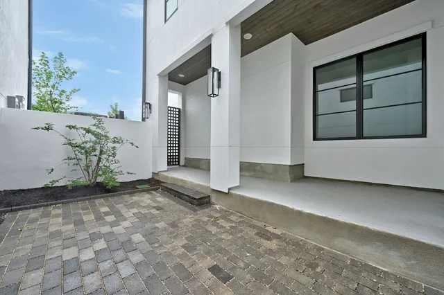 a view of a house with a door and wooden bench