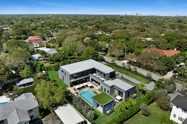 an aerial view of a house with a yard