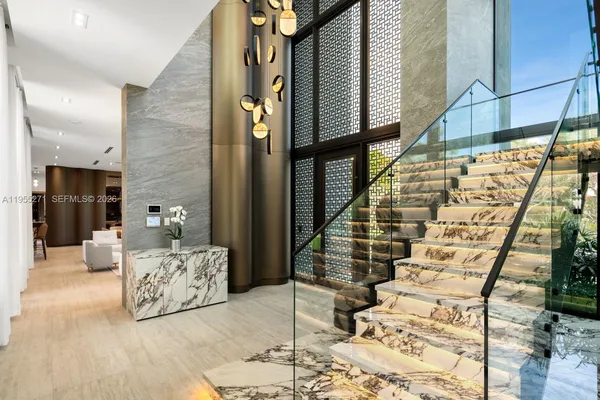 a living room with granite countertop kitchen island stainless steel appliances a sink and a large window