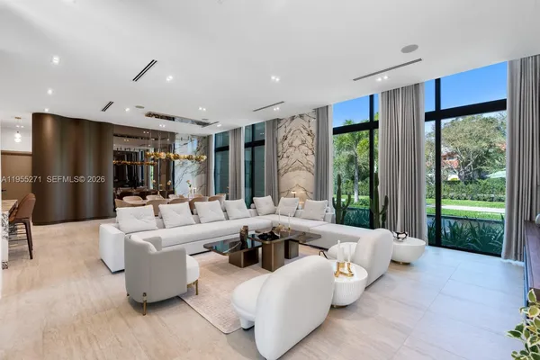 a bedroom with a bed and a large mirror with a chandelier
