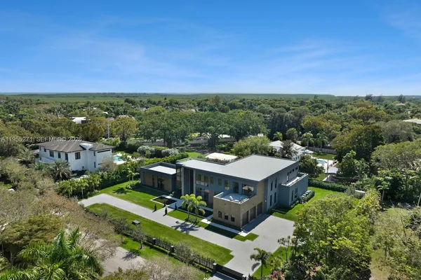 an aerial view of a house with a yard