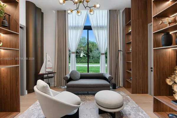 a living room with furniture and large windows
