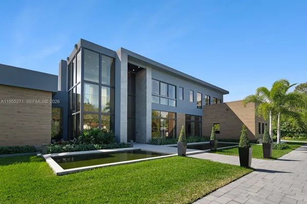a view of a building with couches and swimming pool with a yard