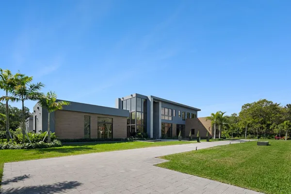 a view of a swimming pool with sitting area and furniture