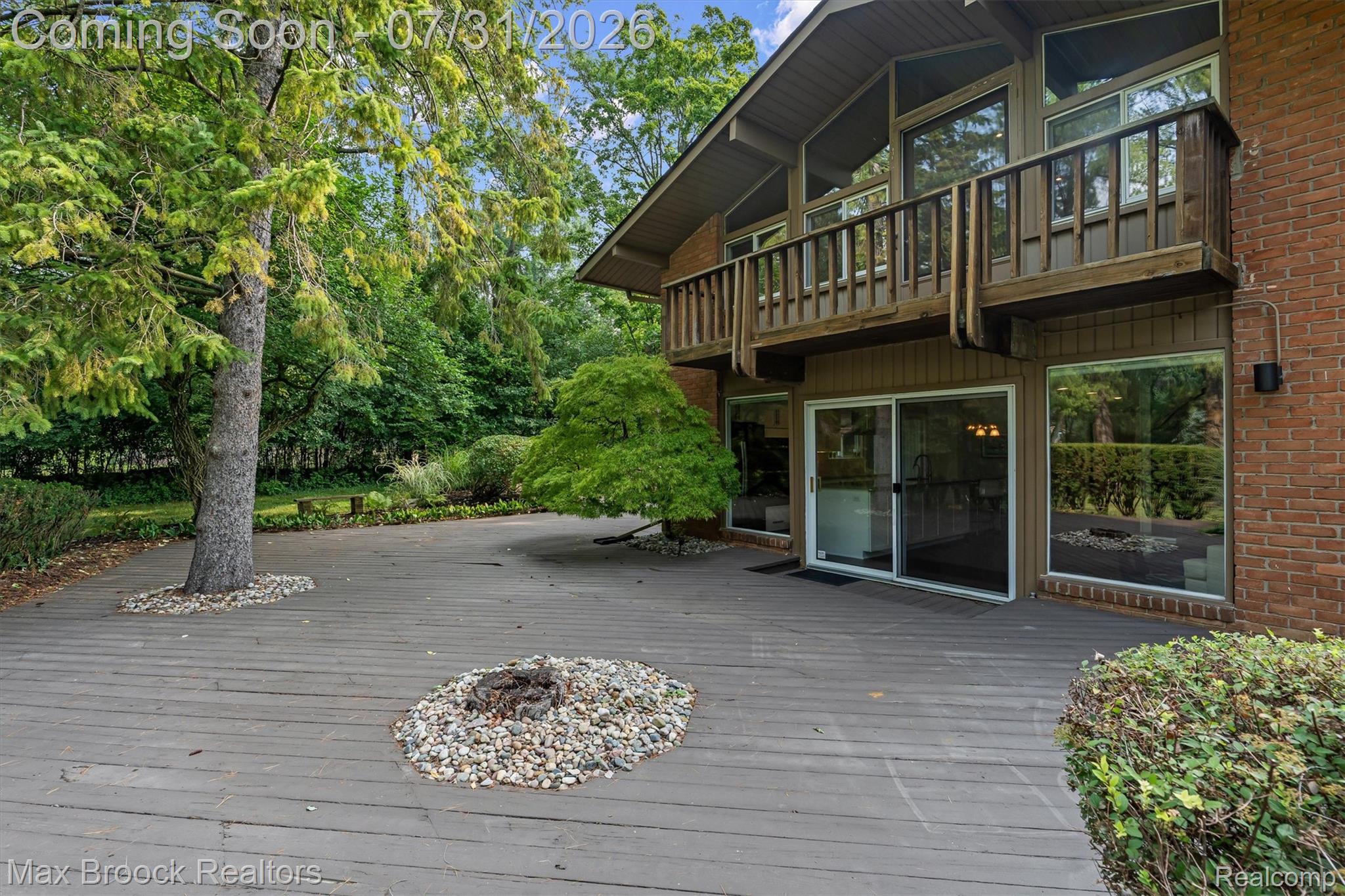 29630 Sugar Spring Road Farmington, MI 48334 - Photo 34 of 41 Expansive outdoor deck featuring mature trees, and direct access to interior spaces via sliding glass doors