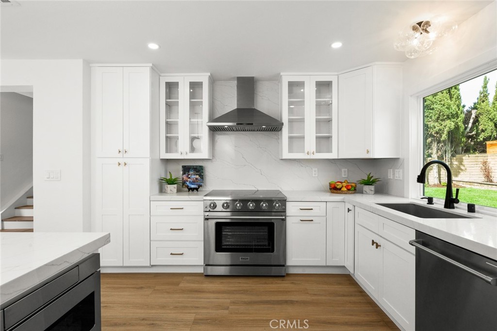 2221 Apple Tree Drive Tustin, CA 92780 - Photo 12 of 30 a kitchen with stainless steel appliances granite countertop a stove and a sink