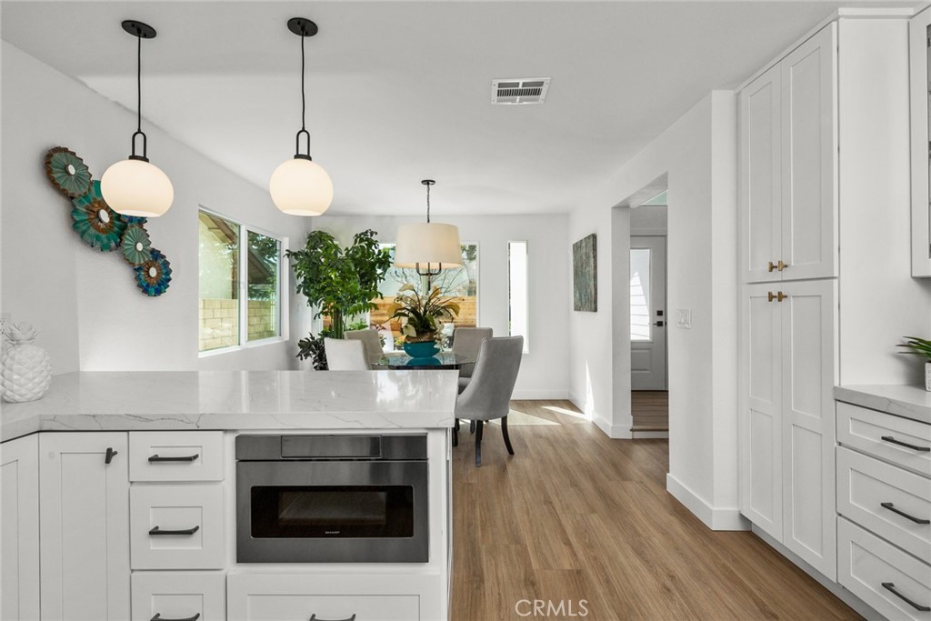 2221 Apple Tree Drive Tustin, CA 92780 - Photo 13 of 30 a kitchen with stainless steel appliances granite countertop a stove a sink and a wooden floor