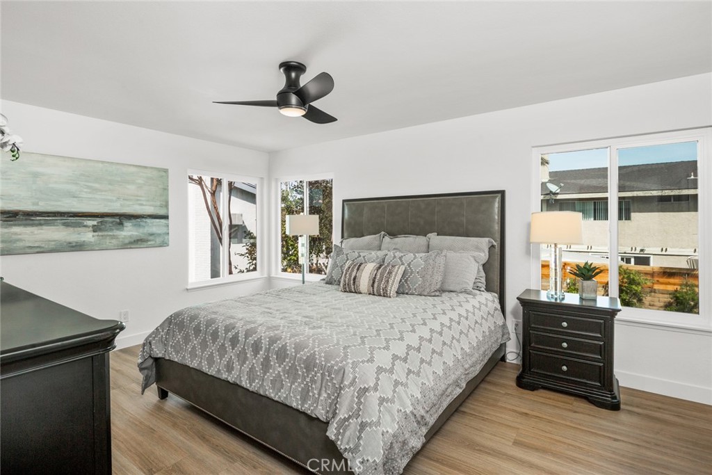 2221 Apple Tree Drive Tustin, CA 92780 - Photo 18 of 30 a bedroom with a bed and wooden floor