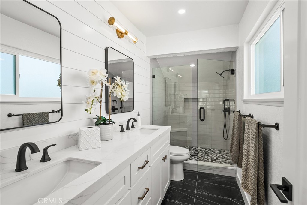 2221 Apple Tree Drive Tustin, CA 92780 - Photo 21 of 30 a bathroom with a double vanity sink mirror and shower