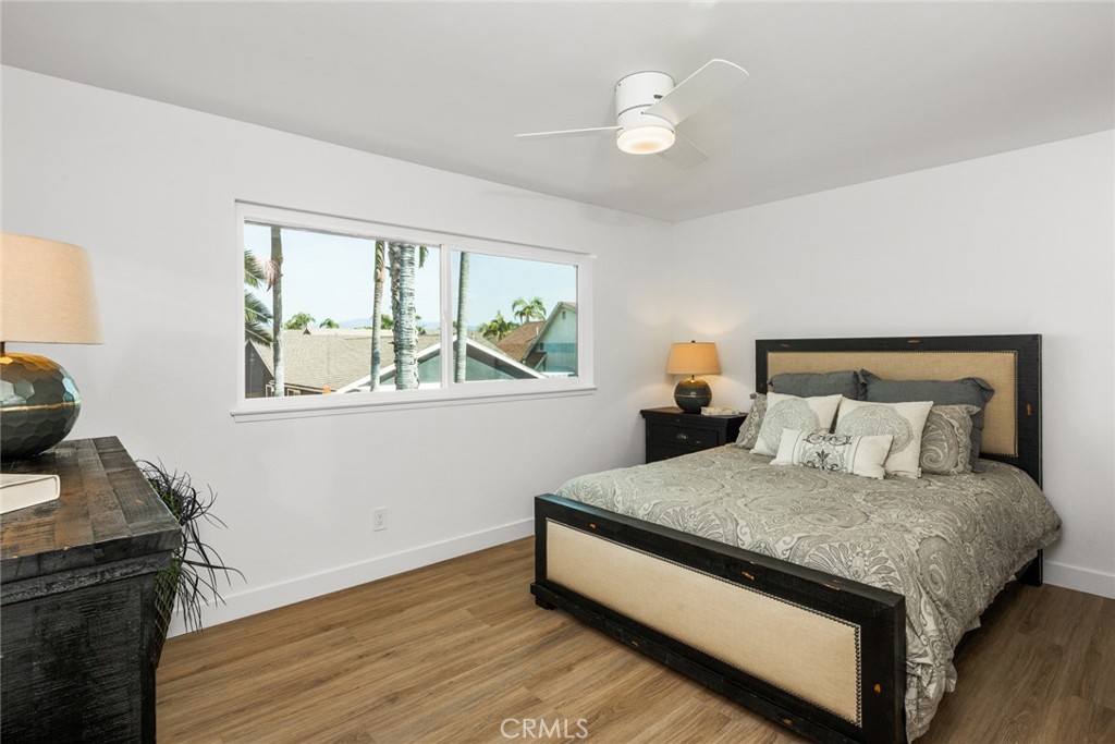 2221 Apple Tree Drive Tustin, CA 92780 - Photo 23 of 30 a bedroom with a bed and a chandelier