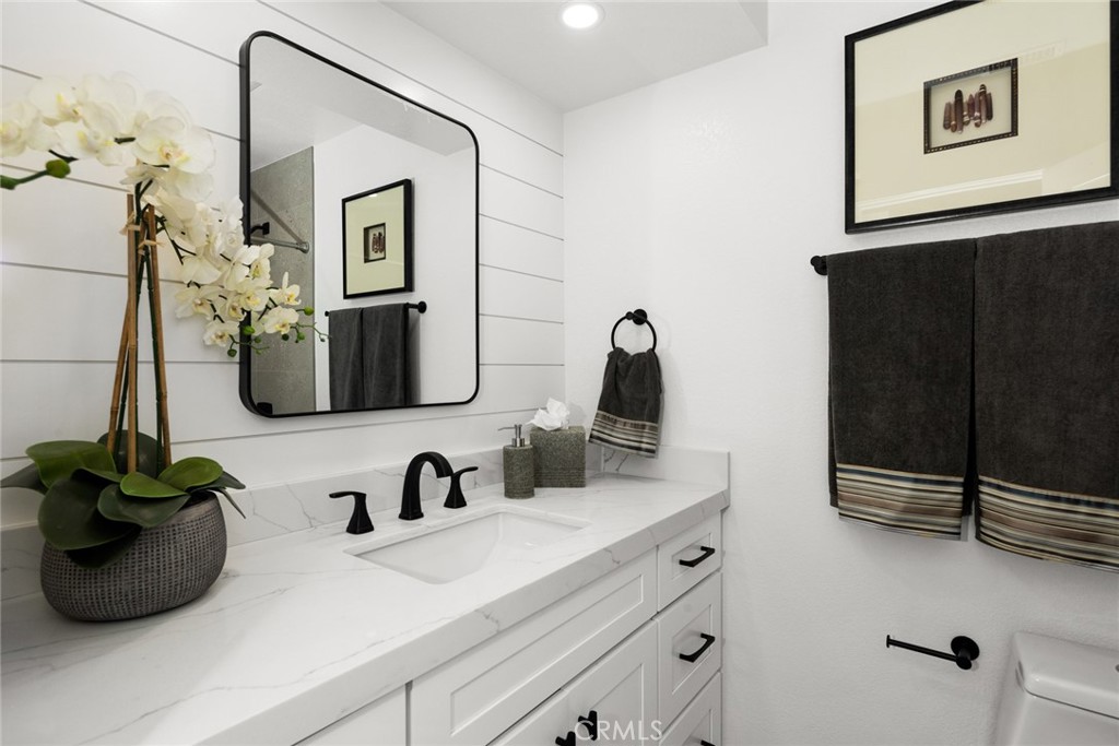 2221 Apple Tree Drive Tustin, CA 92780 - Photo 25 of 30 a bathroom with a sink and a mirror
