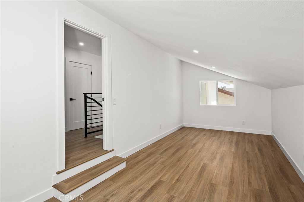 2221 Apple Tree Drive Tustin, CA 92780 - Photo 27 of 30 an empty room with wooden floor and white walls