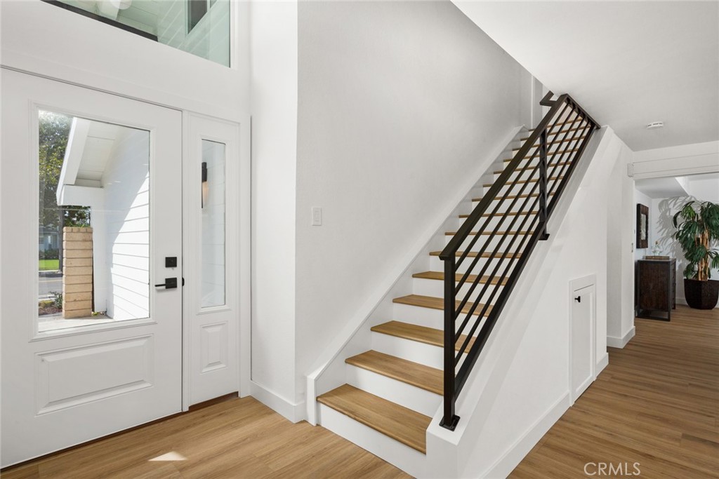 2221 Apple Tree Drive Tustin, CA 92780 - Photo 7 of 30 a view of a hallway with wooden floor and stairs