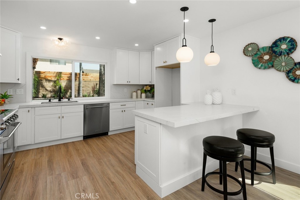 2221 Apple Tree Drive Tustin, CA 92780 - Photo 10 of 30 a kitchen with a sink cabinets and window