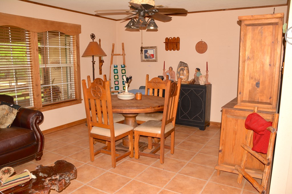 341 Seth Circle Bandera, TX 78003 - Photo 12 of 28 a dining room with furniture and a floor to ceiling window