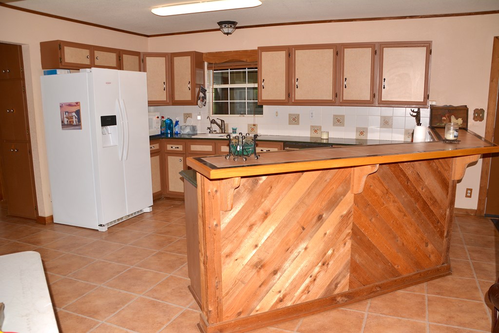 341 Seth Circle Bandera, TX 78003 - Photo 13 of 28 a kitchen with stainless steel appliances granite countertop a refrigerator and a sink