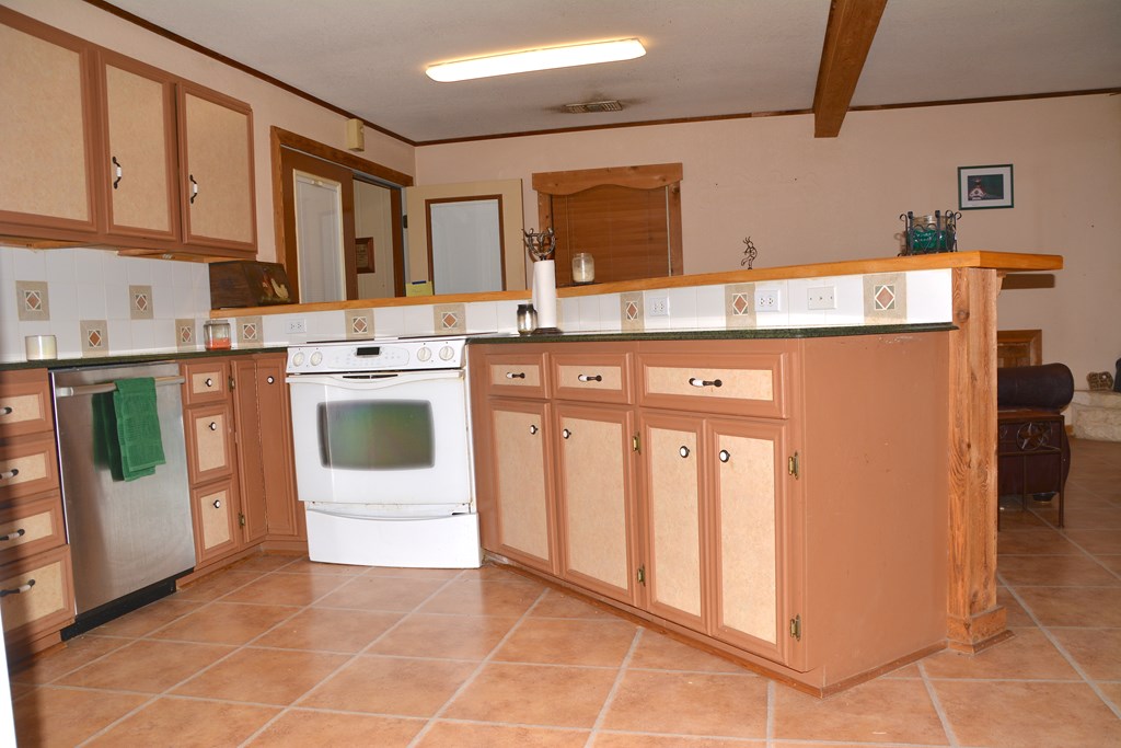 341 Seth Circle Bandera, TX 78003 - Photo 15 of 28 a kitchen with stainless steel appliances granite countertop a refrigerator and a stove