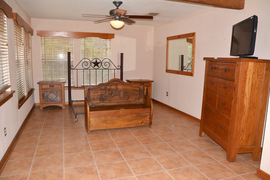 341 Seth Circle Bandera, TX 78003 - Photo 17 of 28 a room with furniture and a flat screen tv