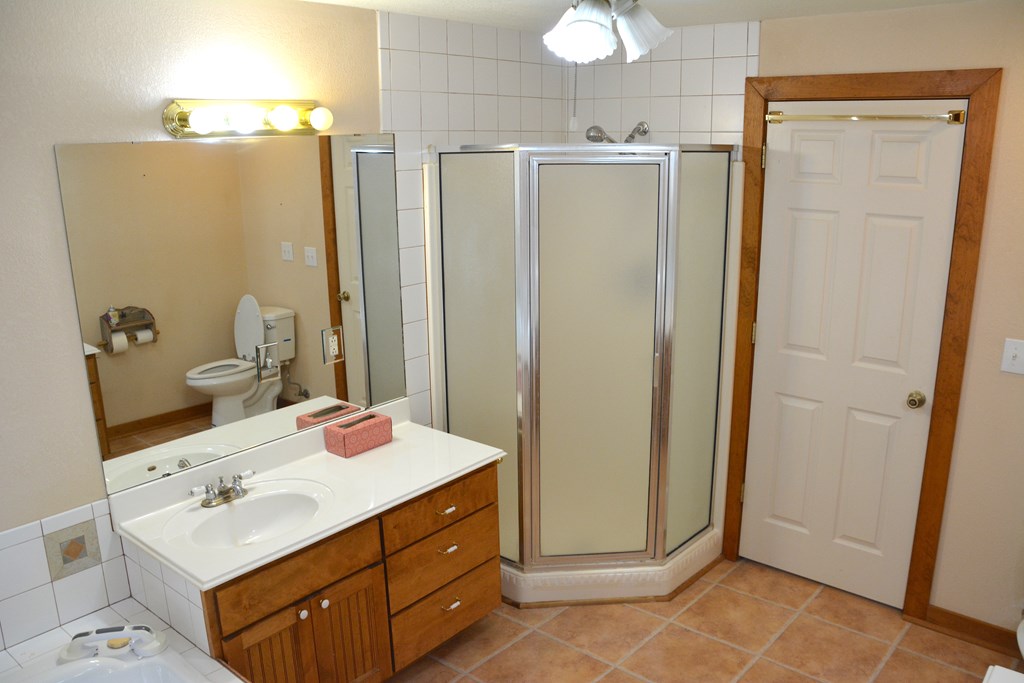 341 Seth Circle Bandera, TX 78003 - Photo 20 of 28 a bathroom with a sink vanity and mirror