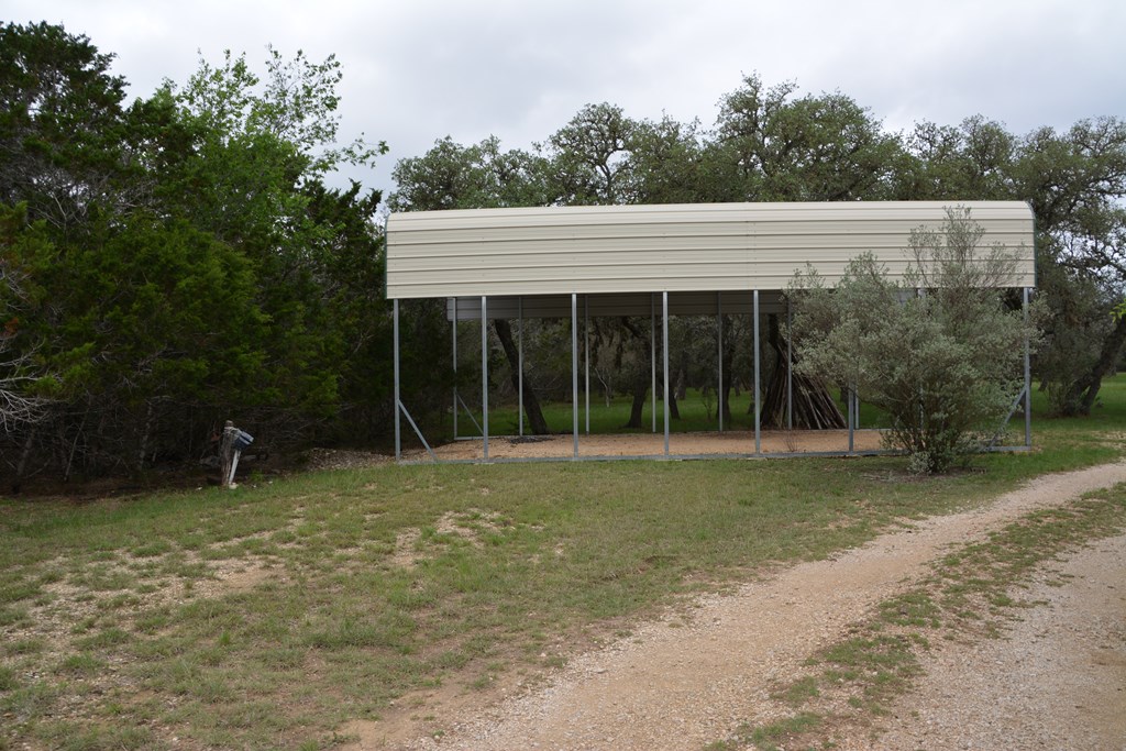 341 Seth Circle Bandera, TX 78003 - Photo 24 of 28 a view of a house with a yard and sitting area